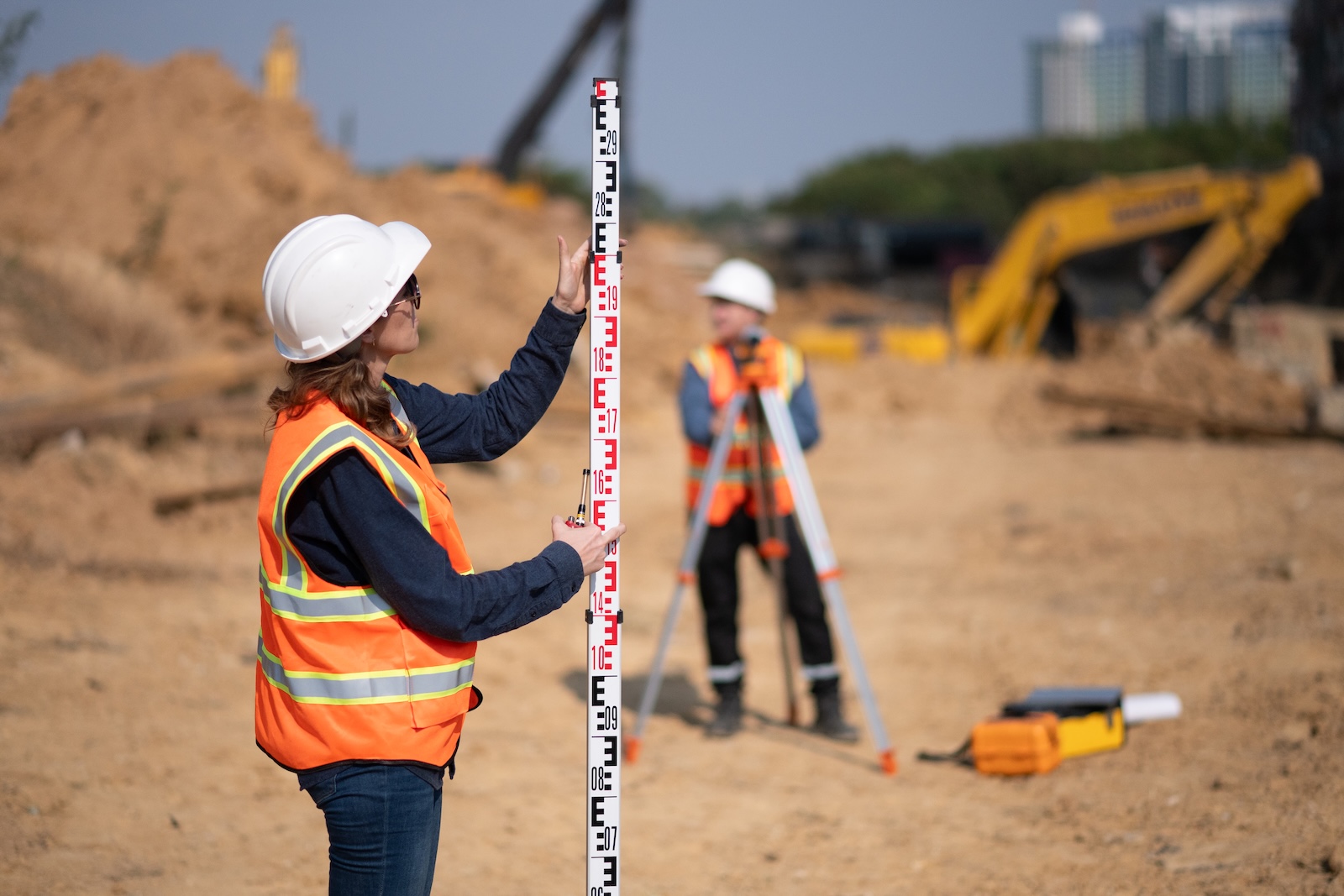 Construction surveyor or engineer working in pipe construction site